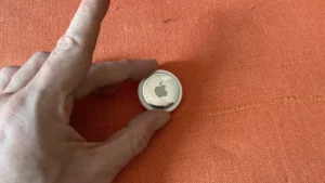 Close-up view of Apple AirTag showing premium build quality and minimalist design elements