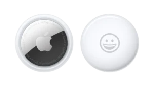 Apple AirTag 4 Pack silver trackers arranged on modern desk showing size comparison with everyday items 